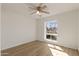 Bedroom features wood floors, ceiling fan, and view to the outside at 2366 E Shea Blvd, Phoenix, AZ 85028