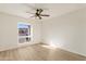 Bedroom features wood floors, ceiling fan, and window at 2366 E Shea Blvd, Phoenix, AZ 85028