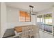 Charming dining area with a wooden table, built-in bench, and views of the backyard patio at 2366 E Shea Blvd, Phoenix, AZ 85028