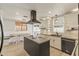 Elegant kitchen with a dark kitchen island, granite countertops, and stainless steel appliances at 2366 E Shea Blvd, Phoenix, AZ 85028