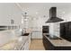 Modern kitchen featuring granite countertops, stainless steel appliances, island cooktop, and white cabinetry at 2366 E Shea Blvd, Phoenix, AZ 85028
