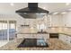 Modern kitchen with white cabinetry, granite countertops, a cooktop island, and stainless steel appliances at 2366 E Shea Blvd, Phoenix, AZ 85028