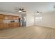 Bright living room with a kitchen area, wood floors, wood cabinets, and stainless steel refrigerator at 2366 E Shea Blvd, Phoenix, AZ 85028