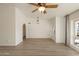 Inviting living room with wood floors, arched doorway, and abundant natural light at 2366 E Shea Blvd, Phoenix, AZ 85028