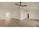 Open living room featuring wood floors, arched doorway and contemporary ceiling fan at 2366 E Shea Blvd, Phoenix, AZ 85028
