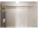 Functional utility room featuring a water heater and a shelf for additional storage at 2366 E Shea Blvd, Phoenix, AZ 85028