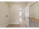 Walk-in closet with wood floor and shelves, leading to bright, updated kitchen at 2366 E Shea Blvd, Phoenix, AZ 85028