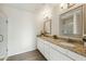 Modern bathroom with dual sinks, granite countertops, and a glass-enclosed shower at 24938 S 190Th Dr, Buckeye, AZ 85326