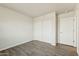 Neutral bedroom with a closet and wood-look tile flooring at 24938 S 190Th Dr, Buckeye, AZ 85326