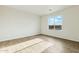 Bright bedroom with a large window offering scenic views and wood-look tile flooring at 24938 S 190Th Dr, Buckeye, AZ 85326
