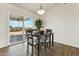 Cozy dining area with a modern light fixture and a sliding glass door to the patio at 24938 S 190Th Dr, Buckeye, AZ 85326