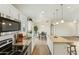 Eat-in kitchen has granite counters, stainless appliances, and a spacious island open to the dining area at 24938 S 190Th Dr, Buckeye, AZ 85326