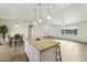 Open kitchen with an island, granite countertops, pendant lighting, dining table, and open floor plan at 24938 S 190Th Dr, Buckeye, AZ 85326