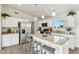 Modern kitchen with white cabinets, stainless steel appliances, and center island with bar seating at 24938 S 190Th Dr, Buckeye, AZ 85326