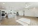 Bright, open living room showcasing wood-look floors and seamless flow to the modern kitchen at 24938 S 190Th Dr, Buckeye, AZ 85326
