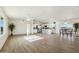 Open-concept living space featuring wood-look floors, ceiling fan, dining area and kitchen island at 24938 S 190Th Dr, Buckeye, AZ 85326