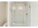 Elegant bathroom with a large, frameless glass shower enclosure and marble tile at 24938 S 190Th Dr, Buckeye, AZ 85326