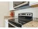 Modern black glass stovetop and oven with stainless steel microwave and granite countertops at 24938 S 190Th Dr, Buckeye, AZ 85326