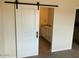 Bathroom view featuring a sliding barn door and vanity with granite counters at 24938 S 190Th Dr, Buckeye, AZ 85326