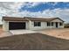 A single-story house featuring a brown roof and beige stucco siding at 24938 S 190Th Dr, Buckeye, AZ 85326