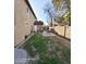 View of the backyard with a grassy lawn, a patio set, and a partial view of the home at 2825 N Villas N Ln, Chandler, AZ 85224