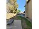View of a grassy backyard with an outdoor patio set and a partial view of the home at 2825 N Villas N Ln, Chandler, AZ 85224