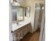 Bathroom featuring an ornate vanity, a large mirror, and an adjacent toilet and shower at 2825 N Villas N Ln, Chandler, AZ 85224