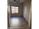 Comfortable bedroom with neutral walls, wood floors, and a window overlooking the backyard at 2825 N Villas N Ln, Chandler, AZ 85224