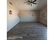 Spacious bedroom offers wood look flooring, ceiling fan, neutral walls, and windows at 2825 N Villas N Ln, Chandler, AZ 85224