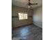 An empty bedroom featuring wood floors, a fan, and natural light at 2825 N Villas N Ln, Chandler, AZ 85224