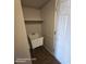 This laundry room features a utility sink with storage shelf, perfect for small clean-up tasks at 2825 N Villas N Ln, Chandler, AZ 85224