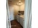 Functional laundry room with washer, dryer, shelving, and direct access to the outdoors at 2825 N Villas N Ln, Chandler, AZ 85224