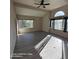 Bright living room with ample windows, ceiling fan, and vinyl plank flooring at 2825 N Villas N Ln, Chandler, AZ 85224
