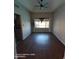 Bright living room featuring wood floors, a ceiling fan and a window with backyard views at 2825 N Villas N Ln, Chandler, AZ 85224