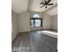 Spacious living room featuring vaulted ceilings, an arched window, and vinyl plank flooring at 2825 N Villas N Ln, Chandler, AZ 85224