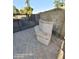 View of an outdoor stone seat on a paved patio with an outdoor kitchen behind a fence at 2825 N Villas N Ln, Chandler, AZ 85224