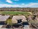 Spacious property with tile roof, desert landscaping, and serene golf course views at 3045 W Feather Sound Dr, Anthem, AZ 85086
