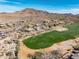High angle aerial shot revealing golf course adjacent homes set within a mountainous desert landscape at 3045 W Feather Sound Dr, Anthem, AZ 85086