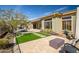 Serene backyard showcases pavers, desert landscaping, and an outdoor kitchen at 3045 W Feather Sound Dr, Anthem, AZ 85086