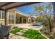 Expansive backyard with desert landscaping, pavers, artificial grass, and a covered patio at 3045 W Feather Sound Dr, Anthem, AZ 85086