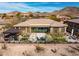 Serene backyard features a covered patio, well-manicured landscaping, and comfortable seating area at 3045 W Feather Sound Dr, Anthem, AZ 85086