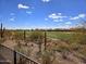 Scenic backyard view featuring a well-manicured golf course, desert plants and blue sky at 3045 W Feather Sound Dr, Anthem, AZ 85086