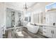 Bright, spacious bathroom featuring a glass shower, soaking tub, white cabinets and wood-look tile floors at 3045 W Feather Sound Dr, Anthem, AZ 85086