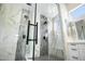 Elegant primary bathroom featuring a spacious glass shower with dual rainfall showerheads and white marble and gray tile at 3045 W Feather Sound Dr, Anthem, AZ 85086