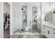 Bright, spacious bathroom featuring a glass shower with dual heads, gray tile accents, and white cabinets at 3045 W Feather Sound Dr, Anthem, AZ 85086