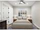 Stylized bedroom with modern ceiling fan, wood-look floors, and lots of natural light at 3045 W Feather Sound Dr, Anthem, AZ 85086