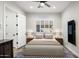 Stylized bedroom with modern ceiling fan, wood-look floors, and lots of natural light at 3045 W Feather Sound Dr, Anthem, AZ 85086
