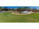 Expansive view of Anthem Country Club entrance with water feature surrounded by manicured lawn at 3045 W Feather Sound Dr, Anthem, AZ 85086