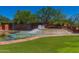 Scenic view of the Anthem Country Club entrance, showcasing water feature and mature trees at 3045 W Feather Sound Dr, Anthem, AZ 85086
