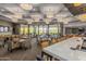 Upscale dining room with elegant lighting, expansive windows, and a stunning view of the surrounding landscape at 3045 W Feather Sound Dr, Anthem, AZ 85086